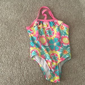 Cute baby girl swimsuit with flowers.